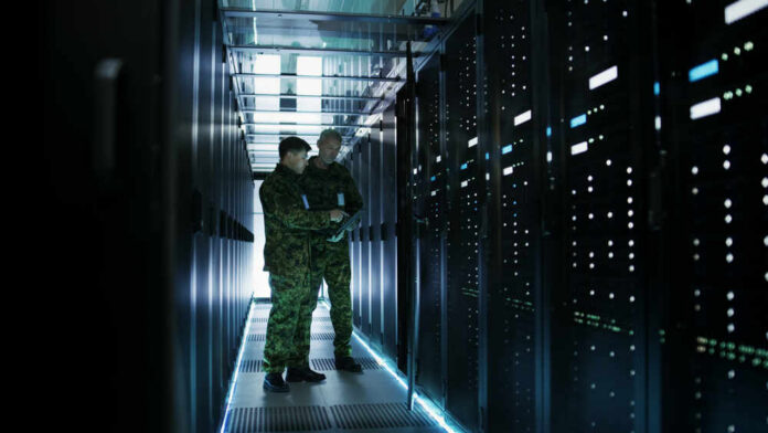 In,Data,Center,Two,Military,Men,Work,With,Open,Server