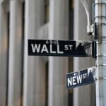 Wall Street PLUMMETS — Worst Drop Since Iran War Street signs for Wall Street and New Street in an urban setting