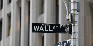 Street signs for Wall Street and New Street in an urban setting