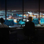Air traffic controllers in airport tower at night