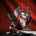 Hong Kong’s Privacy Erosion—A Global Warning Lady Justice scales gavel book Hong Kong flag