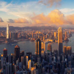 Outrage Erupts: Hong Kong’s Intrusive Phone Law Aerial view of Hong Kong skyline during sunset with clouds