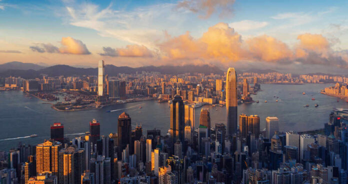 shutterstock_1187684317.jpg Aerial view of Hong Kong skyline during sunset with clouds