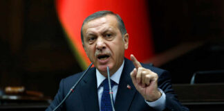 A politician delivering a speech with an emphatic gesture