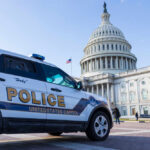 Police vehicle parked in front of the Capitol building