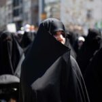 Women in black attire participating in a protest