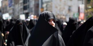 Women in black attire participating in a protest