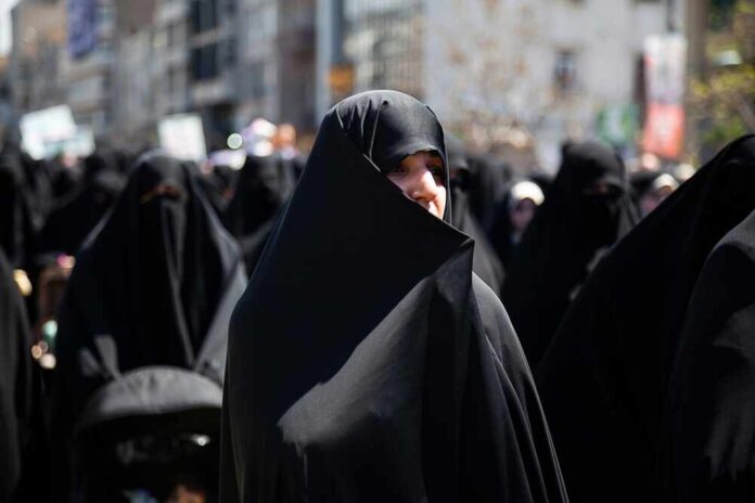 shutterstock_2448200131.jpg Women in black attire participating in a protest