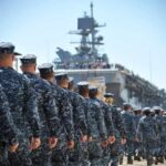 Gecko Robotics’ Bold Move: Saving Navy’s Fleet Navy personnel marching in formation towards a ship