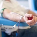 Middle-Class Crisis: Plasma Selling Reveals Economic Truth A person donating blood while holding a stress ball