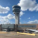 Philadelphia Airport TURNED BATTLEGROUND — Clash with ICE View of an airport control tower and terminal from an airplane window