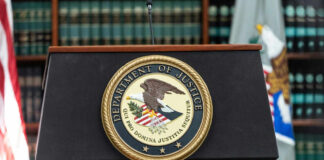 U.S. Department of Justice podium with seal.
