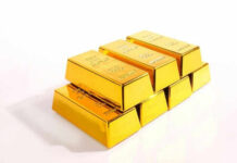 Stack of shiny gold bars on display