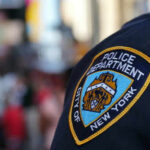 NYPD officer uniform badge closeup in NYC
