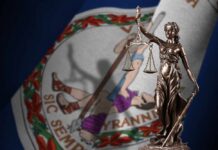 Bronze statue of Lady Justice in front of the Virginia state flag