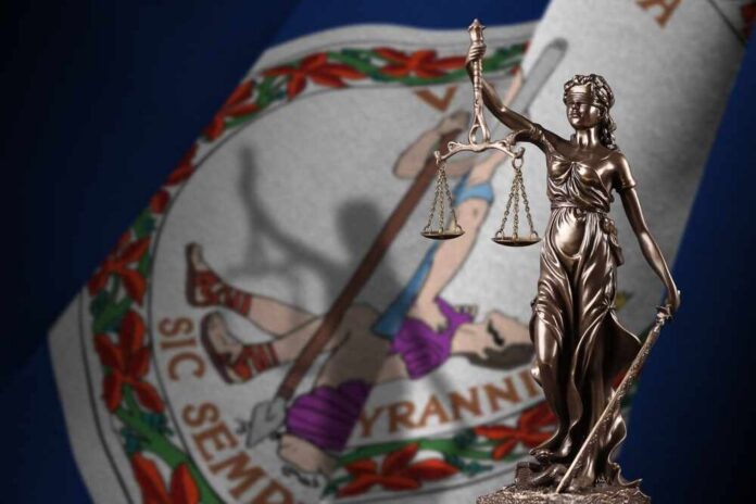 Bronze statue of Lady Justice in front of the Virginia state flag