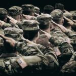 Group of soldiers in uniform saluting during a ceremony