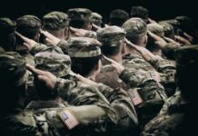 Group of soldiers in uniform saluting during a ceremony