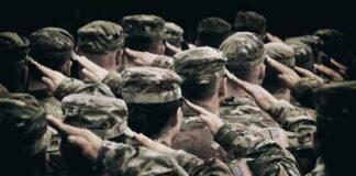 Group of soldiers in uniform saluting during a ceremony