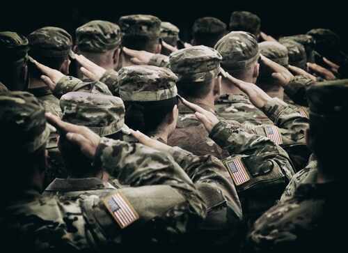 shutterstock_2380882931.jpg Group of soldiers in uniform saluting during a ceremony