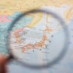 A magnifying glass focusing on a map of Japan
