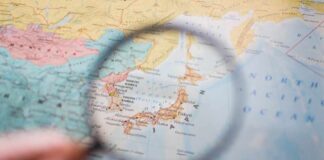A magnifying glass focusing on a map of Japan