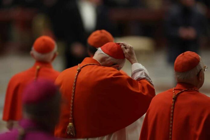 Cardinals in red robes participating in a religious ceremony