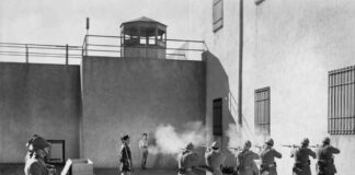 Soldiers executing a prisoner in a military setting