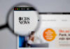CBS News website viewed through a magnifying glass.
