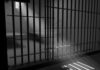 Sunlight streaming through prison cell bars.