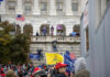 Crowd with flags at U.S. Capitol building.