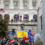 Crowd with flags at U.S. Capitol building.