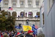 Crowd with flags at U.S. Capitol building.