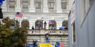 Crowd with flags at U.S. Capitol building.