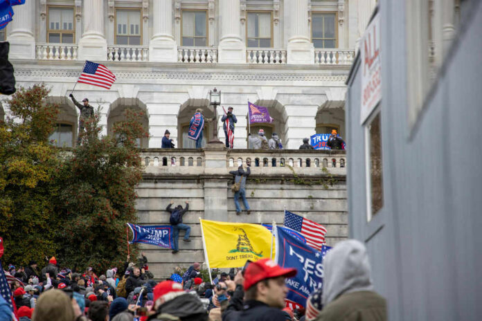 Crowd with flags at U.S. Capitol building.