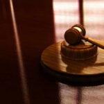 Deportation Showdown: Campus Agitator’s Supreme Court Gambit Gavel on a wooden table in sunlight