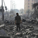 Gaza Mediation Drama: Qatar’s Endless Cycle Person walking through rubblestrewn street in daylight