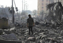 Gaza Mediation Drama: Qatar’s Endless Cycle Person walking through rubblestrewn street in daylight