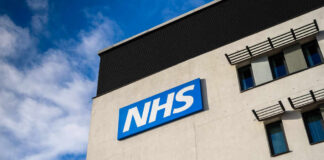 NHS sign on modern hospital building exterior