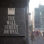 DOJ Subpoenas Journalists — First Amendment CRISIS Sign for The Wall Street Journal on a building in a busy city street
