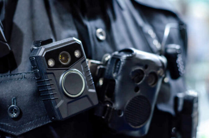 Close-up of a police officer's body camera and communication device