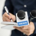 Media Slammed: Overhyping Non-Stories! A journalist holding a notebook and microphones labeled 'NEWS'