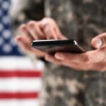 Battlefield Peril: Phone Data Weaponized Against Troops Aerial view through night vision targeting display.
