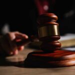 Government Charges SPLC: Dark Money Revelations A wooden gavel resting on a table with a blurred hand in the background