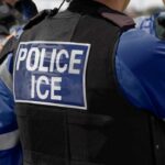 WORLD CUP LOCKDOWN — ICE Role Raises New Questions Close-up of a police officer's vest with 'POLICE ICE' insignia