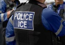 Close-up of a police officer's vest with 'POLICE ICE' insignia