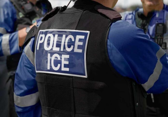 Close-up of a police officer's vest with 'POLICE ICE' insignia