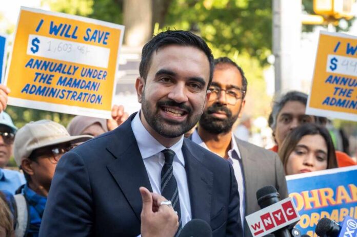 Democratic,New,York,City,Mayoral,Candidate,Zohran,Mamdani,Launches,A A man speaking at a rally with supporters holding protest signs