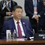Beijing’s Bold Bluff: What’s the Real Strategy? A leader seated at a conference table during an international summit