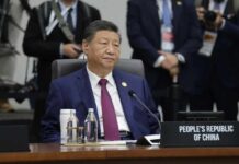 A leader seated at a conference table during an international summit
